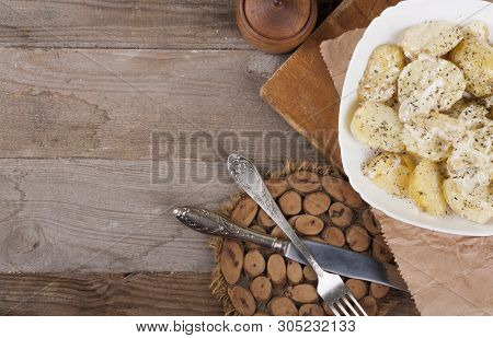 Boiled Potatoes On A White Plate. Dietary Food. Wooden Background, Wooden Cutlery. View From Above