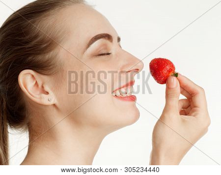 Beautiful Girl Makes Makeup Strawberry Berries On A White Background