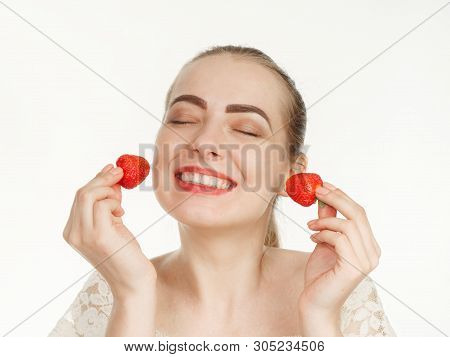 Beautiful Girl Makes Makeup Strawberry Berries On A White Background