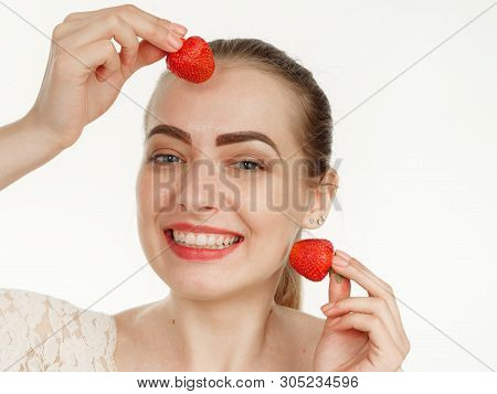 Beautiful Girl Makes Makeup Strawberry Berries On A White Background