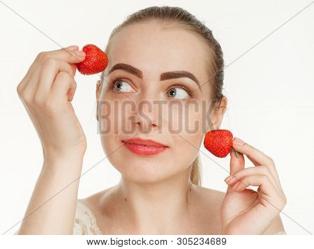 Beautiful Girl Makes Makeup Strawberry Berries On A White Background