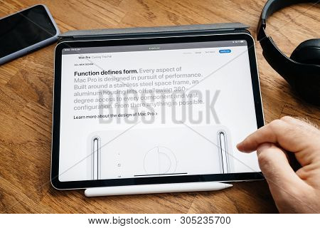 Paris, France - Jun 6, 2019: Man Reading On Apple Ipad Pro Tablet About Latest Announcement Of At De