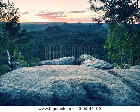 Peak Of Sandstone Rock With View Into Colorful Mist In Morning Valley. Blue Eyllow Daybreak Sun Hidd