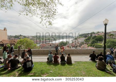 Porto, Portugal: Relaxing People On Hill Over River Douro, With Friends And Nice View Cityscape On 1