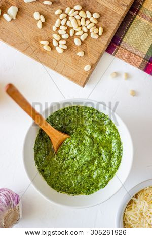 Pesto Sauce And Ingedients On A White Background. Italian Cuisine. Vegetarian Food. The Diet