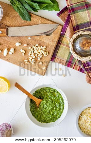 Pesto Sauce And Ingedients On A White Background. Italian Cuisine. Vegetarian Food. The Diet