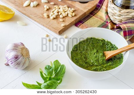 Pesto Sauce And Ingedients On A White Background. Italian Cuisine. Vegetarian Food. The Diet