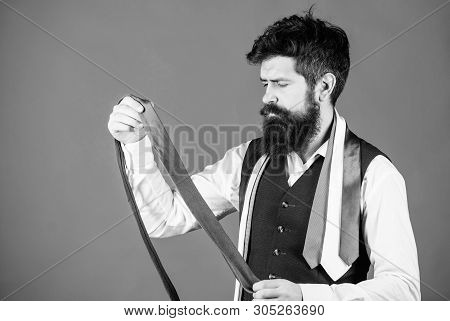 This Grey Tie Is Just The Accessory. Brutal Hipster Holding Luxury Tie Collection. Bearded Man Choos