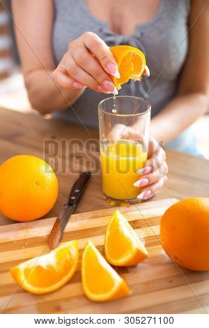 Cooking, Food And Concept Of Veganism, Vigor And Healthy Eating - Close Up Of Female Hand Squeeze Fr