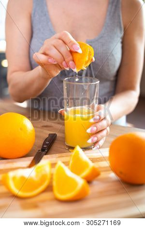 Cooking, Food And Concept Of Veganism, Vigor And Healthy Eating - Close Up Of Female Hand Squeeze Fr