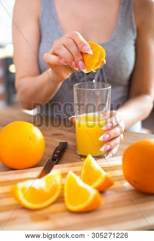 Cooking, Food And Concept Of Veganism, Vigor And Healthy Eating - Close Up Of Female Hand Squeeze Fr