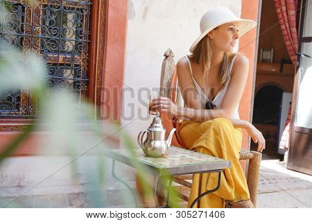 Elegant woman dirnking mint tea in Moroccan riad
