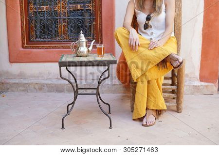 Elegant woman dirnking mint tea in Moroccan riad