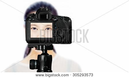 Focus On Live View On Camera On Tripod, Teenage Girl   With Blurred Scene In Background. Teenage Vlo
