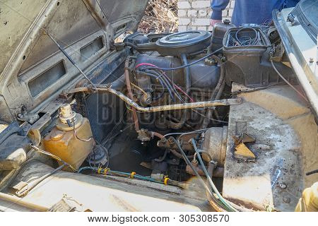 The Engine Compartment Of The Car. Old Dirty Engine