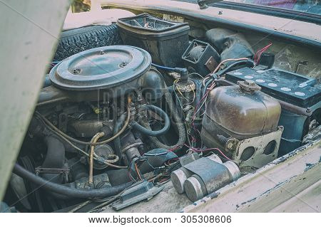 The Engine Compartment Of The Car. Old Dirty Engine