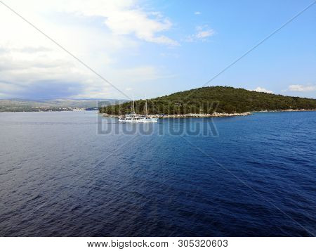 tourist sailing ship and landscape of island Brac near town Milna