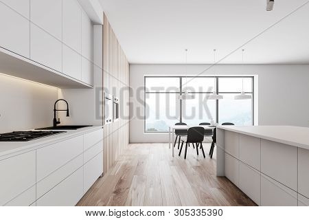Side View Of Kitchen With Table And Counters