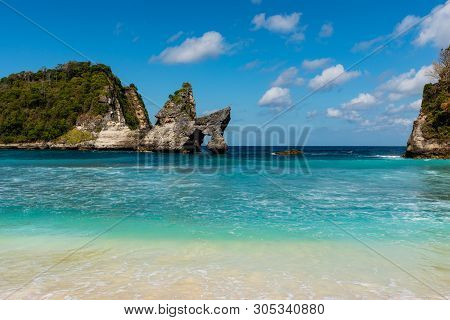 View Of Tropical Beach, Sea Rocks And Turquoise Ocean, Blue Sky. Atuh Beach, Nusa Penida, Indonesia