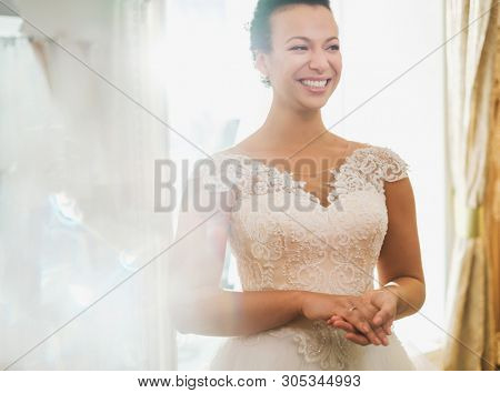 Beautifu bride choosing wedding dress in a wedding salon