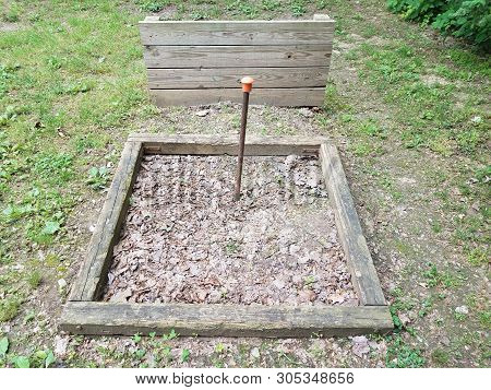 Horseshoe Pit With Metal Pole And Wood Backstop