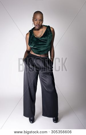 Black African American Female Fashion Model Posing With Trendy Bald Hairstyle And Stylish Clothing I