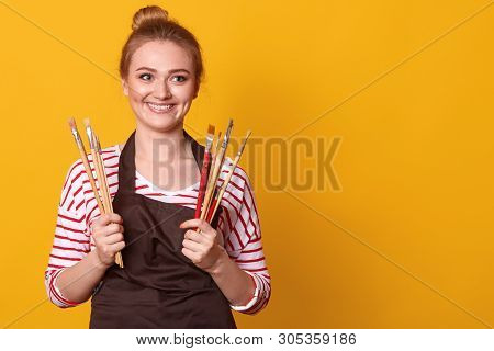 Shot Of Young Caucasian Painter Working In Her Studio. Creative Young Woman Painting On Canvas In He