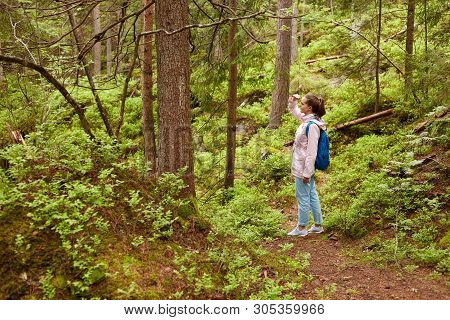 Profile Of Sporty Active Young Female With Pony Tail Wearing Light Pink Jacket, Blue Backback, Jeans