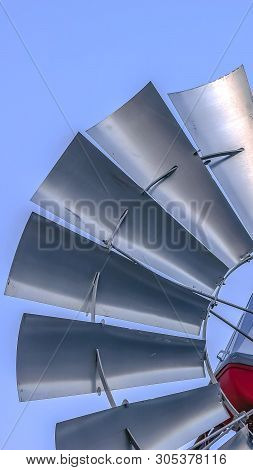 Panorama Close Up Of A Steel Windpump With Pale Blue Sky In The Background