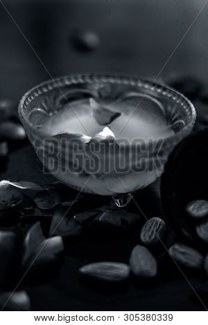 Milk And Almond Face Pack On Black Colored Shiny Surface I.e. Raw Milk,almond,honey Well Mixed In A 
