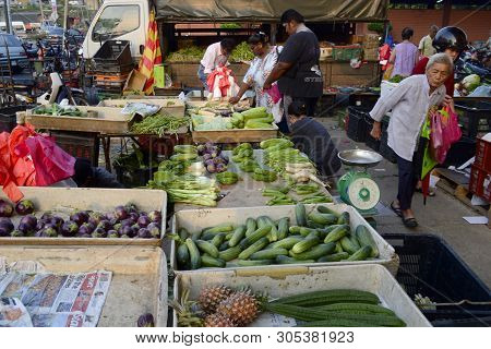 Seremban, Malaysia - 2015 Old Asian Woman Walks On The Street Market In The Morning With Healthy Col