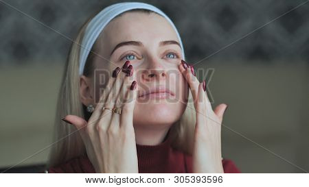 Blonde Girl Applies Concealer On Face Before Make-up.