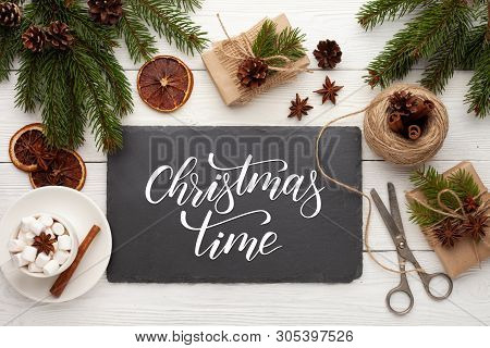 Preparation Christmas Gifts On A White Wooden Table With Fir Branches