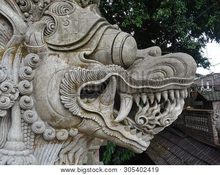 Close Up Picture Of A Traditional Balinese, Dragon Like, Stone Statue Located At The Entrance Of The