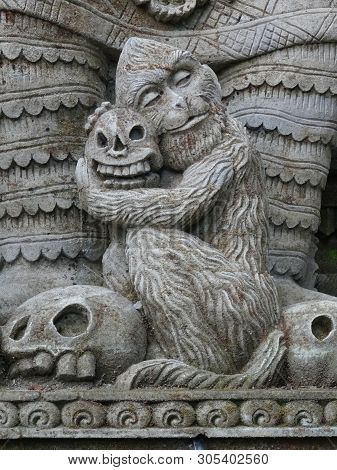 Close Up Picture Of A Stone Detail Representing A Small Monkey Holding A Skull, Located At The Pura 