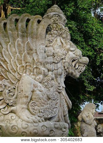 Close Up Picture Of A Traditional Balinese, Dragon Like, Stone Statue Located At The Entrance Of The