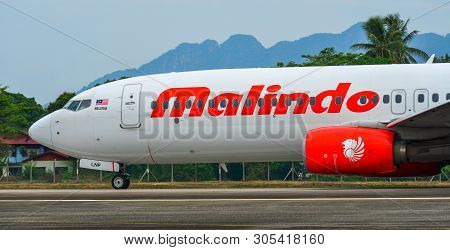 Passenger Airplane Taxiing On Runway Of Airport