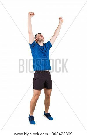 Full Length Portrait Of Young Man Athlete With Hands Raised, Celebrating Victory. Self Overcome Conc