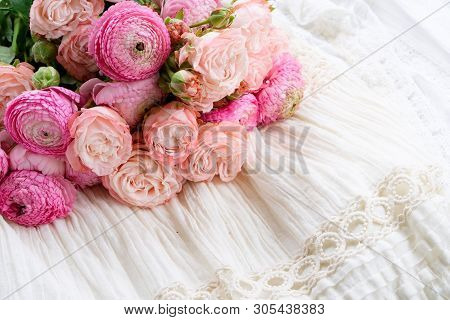 Female Dress And Jewellery With Fresh Rununculus Bouquet On White Dress