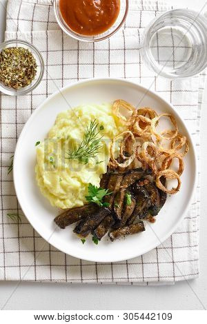 Fried Beef Liver With Mashed Potatoes And Fried Onion Rings On White Plate. Pieces Liver (offal) Fro