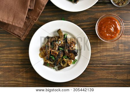 Pieces Cooked Liver (offal) From Beef. Fried Beef Liver With Onion On Plate Over Wooden Background. 