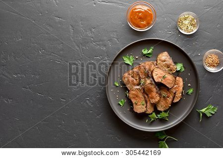 Fried Beef Liver On Plate Over Black Stone Background With Copy Space. Cooked Liver(offal) From Beef