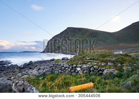 Grass Roof Cabin (stokkvika) At The Coast During Sunset On Lofoten Islands In Norway Near Fredvang.