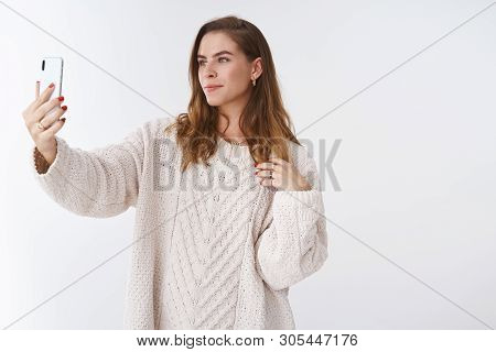 Glamour Self-assured Attractive Woman Short Hair Loose Trendy Sweater Posing Extended Arm Smartphone