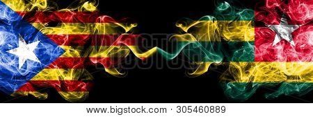Catalonia Vs Togo, Togolese Smoke Flags Placed Side By Side. Thick Colored Silky Smoke Flags Of Cata