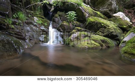 Waterfall With Swimming Hole Along Hiking Trail During Vacation Travel