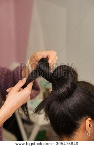 Hair Stylist Hands Form High Tuft Of Hair. Learning To Create An Evening Hairstyle. Hairdressing Wor
