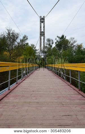 View Of The Bridge With Yellow Railings And Taut Cables Across The River On Mount Kizilovka In The F