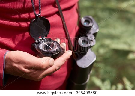 Faceless Photo Of Man's Hand With Compass, Traveler On Wooden Background Wearing Red Casual Shirt, P