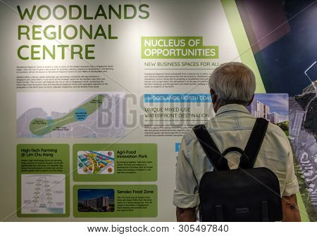 Singapore-05 Apr 2019:old Man Watching The New Singapore Master Plan In Ura
